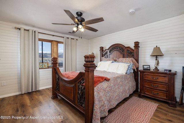 bedroom with ceiling fan and dark wood-type flooring