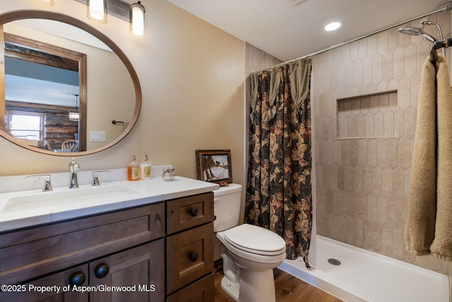 full bathroom featuring wood finished floors, vanity, toilet, and a shower with curtain