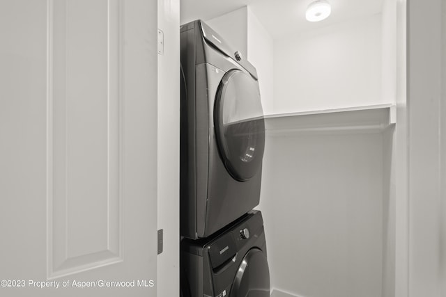 laundry room featuring stacked washing maching and dryer