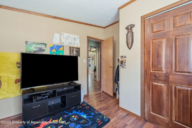 1137 Rose St, Craig, CO 81625 - living area featuring wood finished floors, crown molding, and a textured ceiling