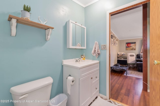 1137 Rose St, Craig, CO 81625 - half bathroom featuring ornamental molding, vanity, and wood finished floors