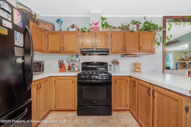 1137 Rose St, Craig, CO 81625 - kitchen with black appliances, under cabinet range hood, light countertops, crown molding, and brown cabinetry