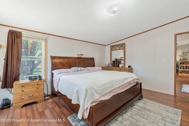 1137 Rose St, Craig, CO 81625 - bedroom featuring crown molding, lofted ceiling, wood finished floors, and a textured ceiling
