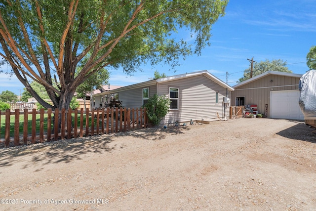 1137 Rose St, Craig, CO 81625 - view of front of property with a garage, an outdoor structure, and dirt driveway