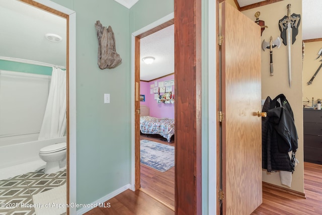 1137 Rose St, Craig, CO 81625 - ensuite bathroom featuring wood finished floors and shower / tub combo