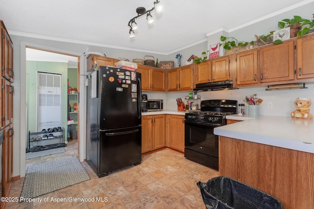 1137 Rose St, Craig, CO 81625 - kitchen featuring black appliances, under cabinet range hood, light countertops, a heating unit, and ornamental molding
