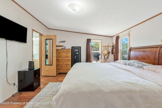 1137 Rose St, Craig, CO 81625 - bedroom with ornamental molding, light wood finished floors, a textured ceiling, and vaulted ceiling
