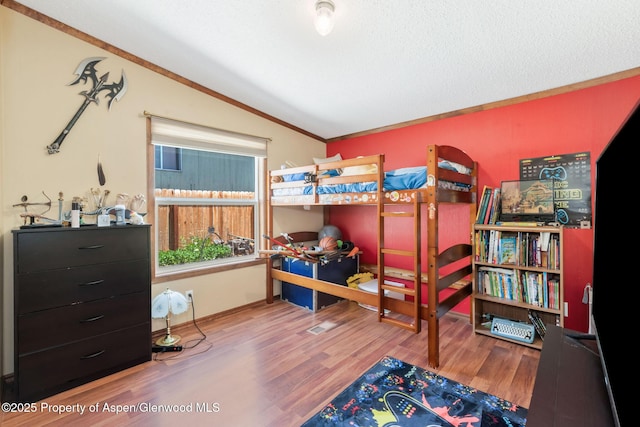 1137 Rose St, Craig, CO 81625 - bedroom with lofted ceiling, wood finished floors, and ornamental molding