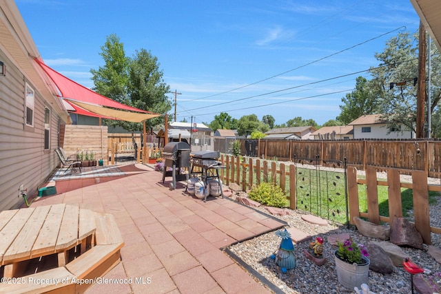 1137 Rose St, Craig, CO 81625 - fenced backyard featuring a grill, a patio, and outdoor dining space