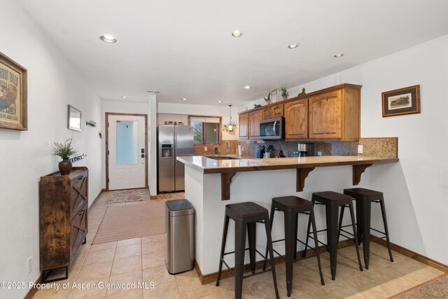 1468 W Main St, Carbondale, CO 81623 - living room with an accent wall, a barn door, carpet floors, and baseboards