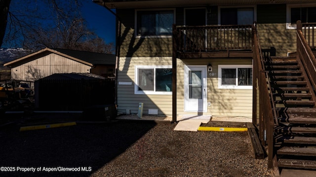 rear view of property featuring stairway