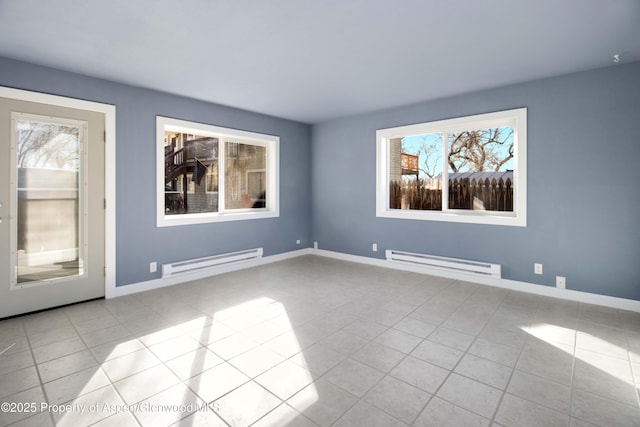 tiled empty room featuring baseboards and baseboard heating