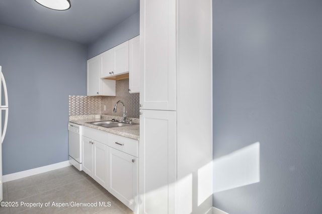 kitchen with light countertops, decorative backsplash, white dishwasher, white cabinetry, and a sink