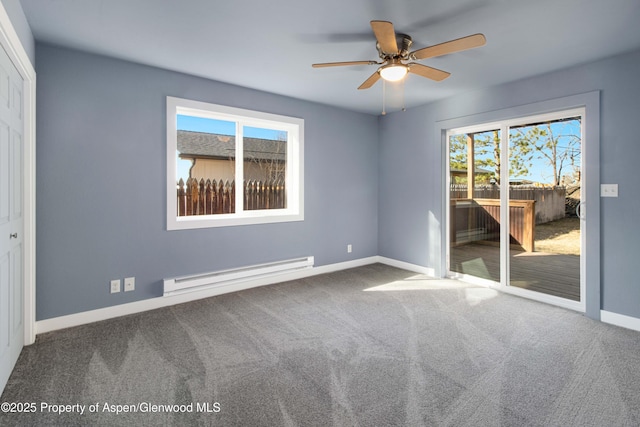 carpeted spare room with ceiling fan, baseboards, a wealth of natural light, and a baseboard radiator