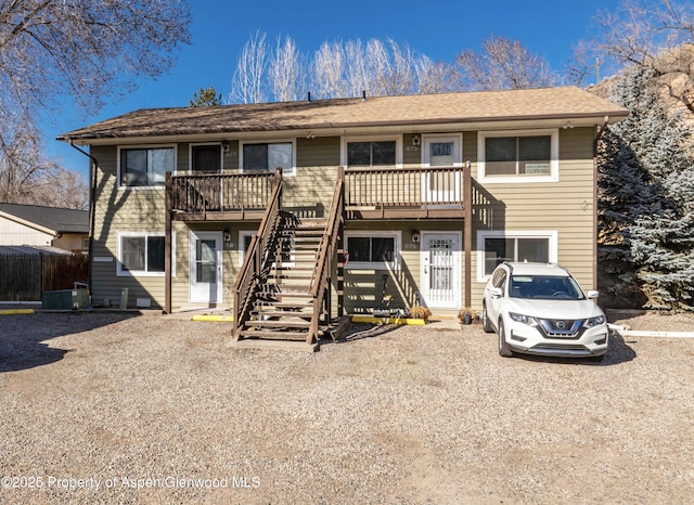 view of front of home with stairs and central AC unit