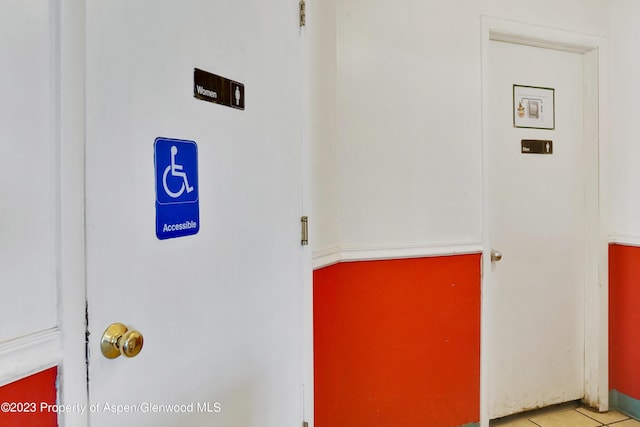 clothes washing area featuring light tile patterned floors