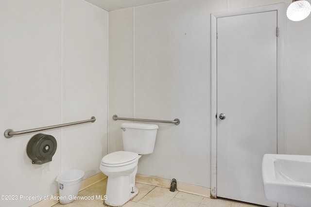 bathroom with tile patterned flooring, toilet, and sink