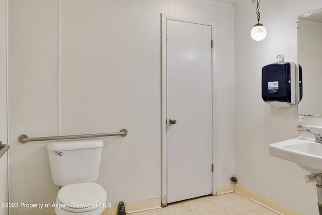 bathroom featuring tile patterned floors, toilet, and sink