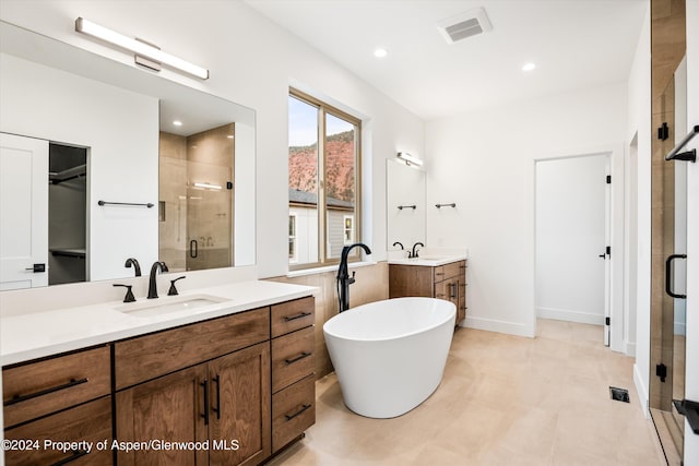 bathroom with vanity and independent shower and bath