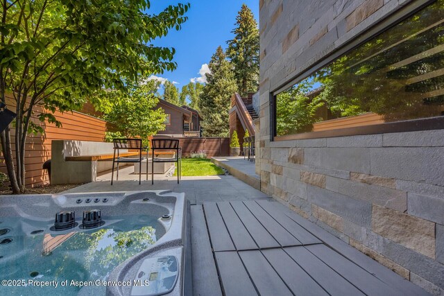 700 W Smuggler St, Aspen, CO 81611 - kitchen with beverage cooler, tasteful backsplash, a kitchen island with sink, modern cabinets, and extractor fan