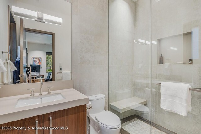 700 W Smuggler St, Aspen, CO 81611 - bathroom with tile walls, a tile shower, and vanity