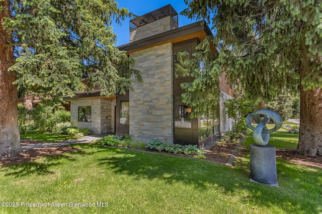 700 W Smuggler St, Aspen, CO 81611 - living room featuring a towering ceiling, plenty of natural light, wood finished floors, and a large fireplace