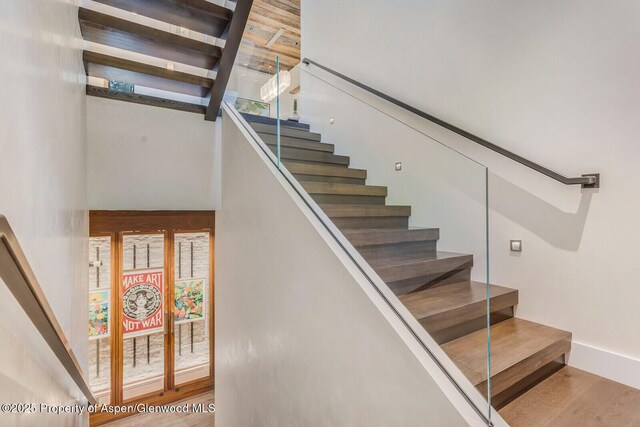 700 W Smuggler St, Aspen, CO 81611 - stairs featuring wood finished floors and a high ceiling