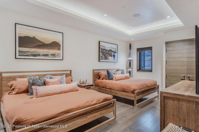 700 W Smuggler St, Aspen, CO 81611 - bedroom with hardwood / wood-style flooring, a raised ceiling, and recessed lighting