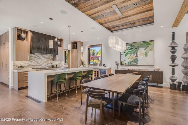 700 W Smuggler St, Aspen, CO 81611 - living room with dark wood-type flooring, bar with sink, a tray ceiling, recessed lighting, and a tile fireplace