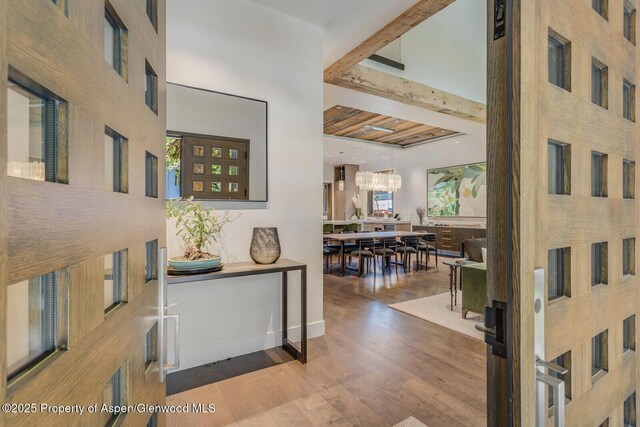 700 W Smuggler St, Aspen, CO 81611 - bedroom with a stone fireplace and wood finished floors