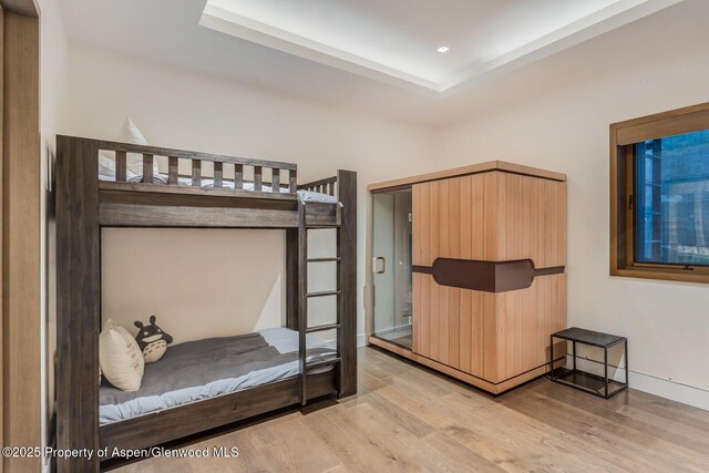 700 W Smuggler St, Aspen, CO 81611 - unfurnished bedroom with light wood finished floors, recessed lighting, and a raised ceiling