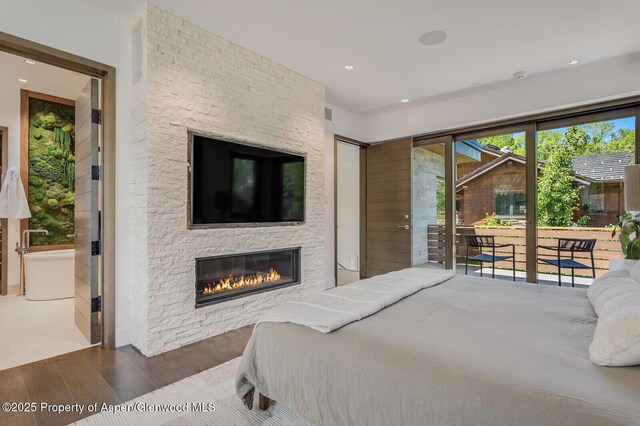700 W Smuggler St, Aspen, CO 81611 - bedroom with access to outside, wood finished floors, a stone fireplace, and recessed lighting