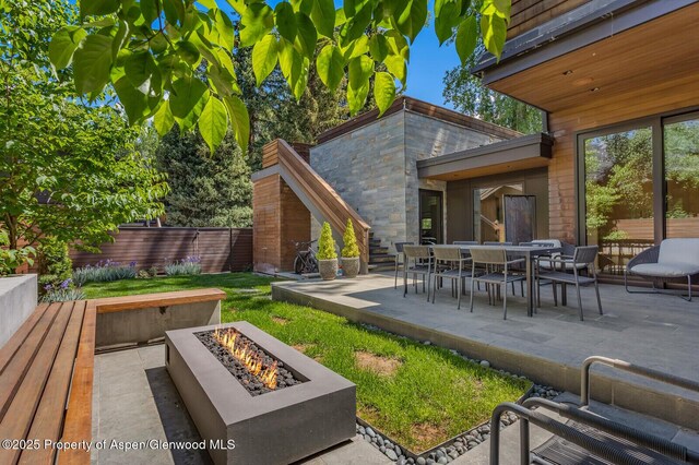 700 W Smuggler St, Aspen, CO 81611 - dining space featuring a towering ceiling, wood finished floors, a chandelier, and a large fireplace