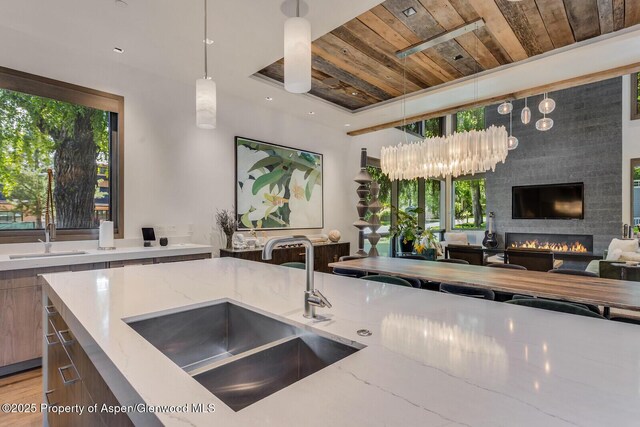 700 W Smuggler St, Aspen, CO 81611 - kitchen with wood ceiling, light stone counters, open floor plan, and plenty of natural light