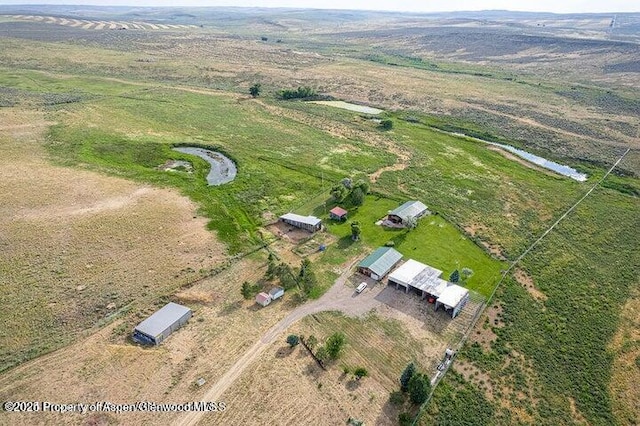 birds eye view of property featuring a rural view