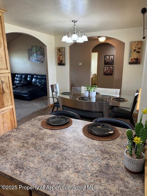 3695 W W 6th St, Craig, CO 81625 - dining area with arched walkways and a chandelier