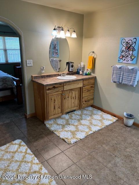3695 W W 6th St, Craig, CO 81625 - bathroom with vanity, ensuite bath, baseboards, and tile patterned floors
