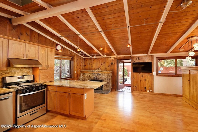 kitchen with kitchen peninsula, appliances with stainless steel finishes, lofted ceiling with beams, and wooden ceiling