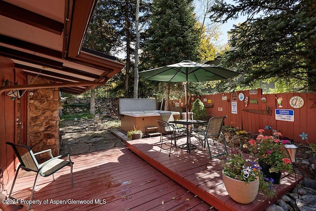 wooden terrace with a hot tub