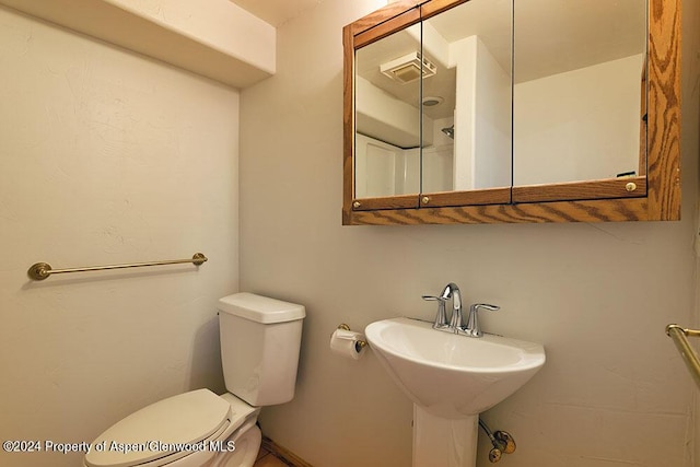 bathroom featuring sink and toilet