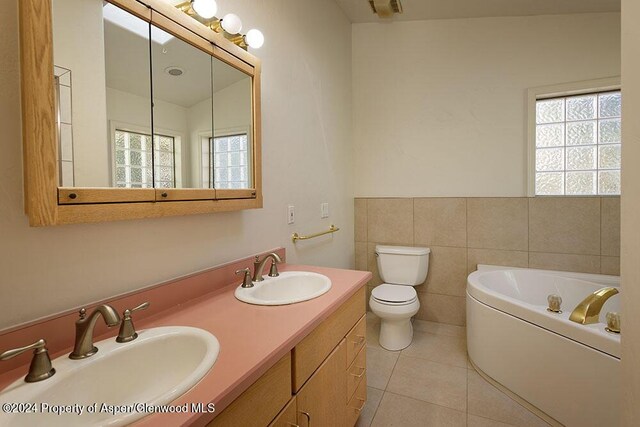 bathroom featuring a bathing tub, tile patterned flooring, lofted ceiling, toilet, and tile walls