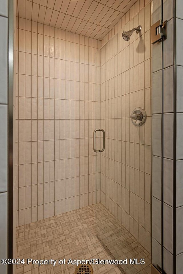 bathroom featuring a shower with door