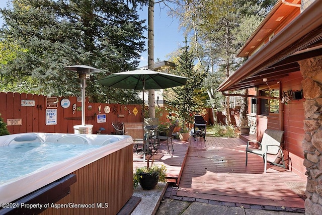 wooden terrace featuring grilling area and a hot tub