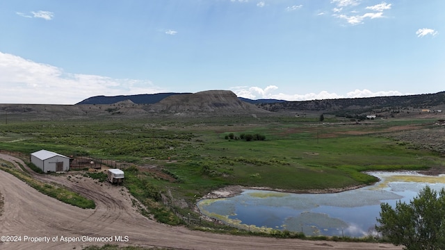 view of mountain feature with a rural view and a water view