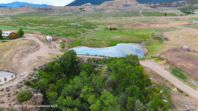 bird's eye view with a rural view and a water and mountain view