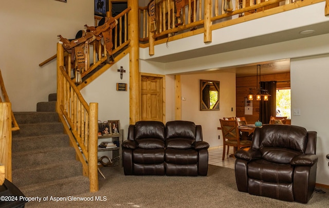 living room featuring carpet and an inviting chandelier