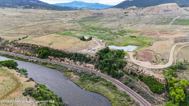 drone / aerial view with a water and mountain view