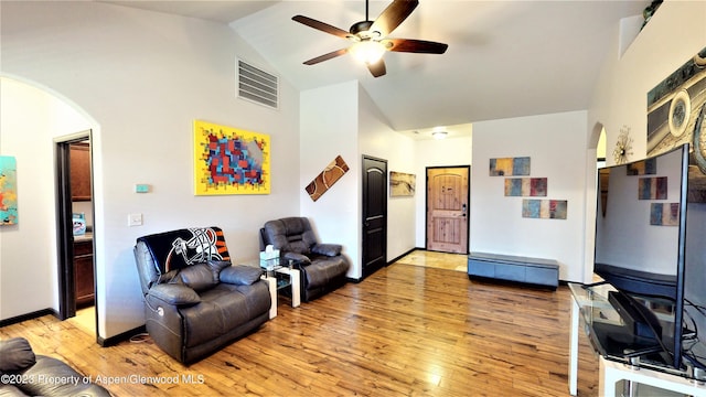 living room with ceiling fan, high vaulted ceiling, and light hardwood / wood-style floors