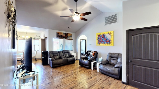 living room featuring ceiling fan with notable chandelier, hardwood / wood-style flooring, and lofted ceiling