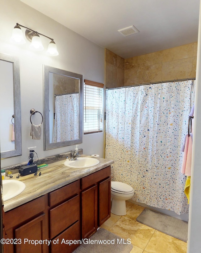 bathroom with a shower with shower curtain, vanity, toilet, and tile patterned flooring